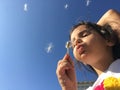 A little girl blowing dandelion seeds. Royalty Free Stock Photo