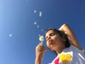 A little girl blowing dandelion seeds. Royalty Free Stock Photo