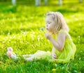 Little girl blowing dandelion Royalty Free Stock Photo