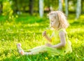 Little girl blowing dandelion Royalty Free Stock Photo