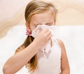 Little girl blowing her nose in a great effort Royalty Free Stock Photo