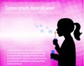 Little girl blowing soap bubbles over abstract pink background