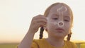 little girl blowing soap bubbles park. happy family. child kid daughter plays game outdoor. baby kid plays soap bubbles Royalty Free Stock Photo