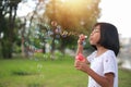 A little girl blowing soap bubbles in summer park Royalty Free Stock Photo