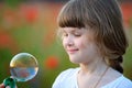 A little girl blowing soap bubbles in summer park Royalty Free Stock Photo