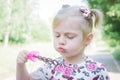 A little girl blowing soap bubbles in summer park Royalty Free Stock Photo