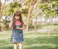 A little girl blowing soap bubbles in summer park. Royalty Free Stock Photo