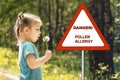 Little girl blows on dandelion. warning sign: danger pollen allergy Royalty Free Stock Photo