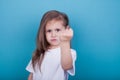 A little girl threatens with a fist