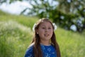 Little Girl in Blue Dress Smiling in Front of Field with Flowers Royalty Free Stock Photo