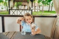 Little girl eat ice cream in cafe outdoors Royalty Free Stock Photo