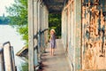 Little girl standing on porch of old ruined house. Royalty Free Stock Photo