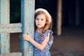 Little girl standing on porch of old ruined house. Royalty Free Stock Photo