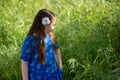 Little Girl in Blue Dress looking at golden field at park