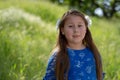 Little Girl in Blue Dress Smiling in Front of Field with Flowers Royalty Free Stock Photo