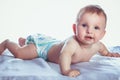 Little girl blue eyes lies in diapers Royalty Free Stock Photo