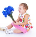 Little girl with blue flowers Royalty Free Stock Photo