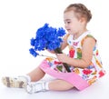 Little girl with blue flowers Royalty Free Stock Photo