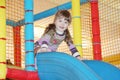 Little girl on blue plastic slide