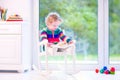 Little girl with a book in a rocking chair Royalty Free Stock Photo