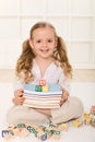 Little girl with books and alphabet wooden blocks Royalty Free Stock Photo