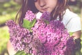 Little girl with bouquet of lilac in her hands Royalty Free Stock Photo