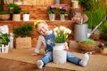 Little girl with a bouquet of white tulips sits on porch of a wooden house, around green houseplants and flowers. Childhood concep