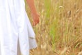 Little girl with a bouquet of wildflowers in her hands in a wheat field.