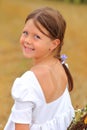 Little girl with a bouquet of wildflowers in her hands in a wheat field. Royalty Free Stock Photo