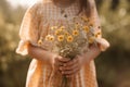 Little girl with bouquet of wildflowers outdoors, closeup, Midsection of a cute little girl without face holding flowers, AI Royalty Free Stock Photo