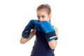 Little girl in boxing gloves practicing and looking at the camera Royalty Free Stock Photo
