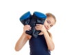 Little girl after boxing practicing with gloves in hands looking at the camera Royalty Free Stock Photo