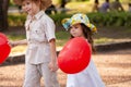 Little girl and boy with balloons in the park Royalty Free Stock Photo