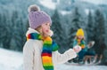 Little girl and boy enjoying a day out playing in the winter forest. Children siblings having fun in beautiful winter Royalty Free Stock Photo