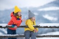 Little girl and boy enjoying a day out playing in the winter forest. Children siblings having fun in beautiful winter Royalty Free Stock Photo