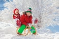 Little girl and boy enjoying sleigh ride. Child sledding. Toddler kid riding a sledge. Children play outdoors in snow. Kids sled Royalty Free Stock Photo