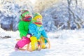 Kids play in snow. Winter sled ride for children Royalty Free Stock Photo