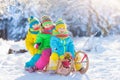 Kids play in snow. Winter sled ride for children Royalty Free Stock Photo