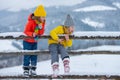 Little girl and boy enjoying winter. Children play outdoors in snow. Outdoor fun for family Christmas vacation. Royalty Free Stock Photo