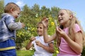 A little girl and a boy inflate soap bubbles for a joyful baby Royalty Free Stock Photo