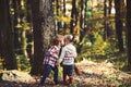 Little girl and little boy kissing in autumn forest Royalty Free Stock Photo