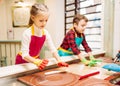 Little girl and boy learn to make caramel