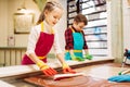 Little girl and boy learn to make caramel