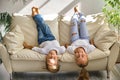 Little girl and boy are lying on their backs on sofa Royalty Free Stock Photo