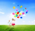 Little Girl and Boy Outdoors Holding Balloons Royalty Free Stock Photo