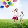 Little Girl and Boy Outdoors Holding Balloons Concept Royalty Free Stock Photo