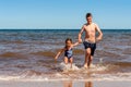 Little girl and boy playing on the Cavendish beach