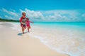 Little girl and boy run play with water on beach Royalty Free Stock Photo