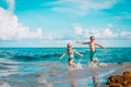 little girl and boy run and play with water at beach Royalty Free Stock Photo