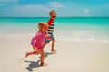 Little girl and boy run play with water on beach Royalty Free Stock Photo